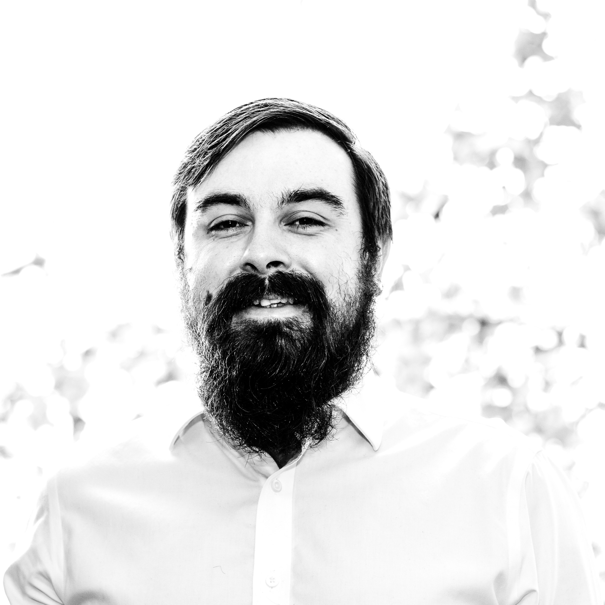 Headshot taken in the living room with a tree behind. Over-exposed backlight.